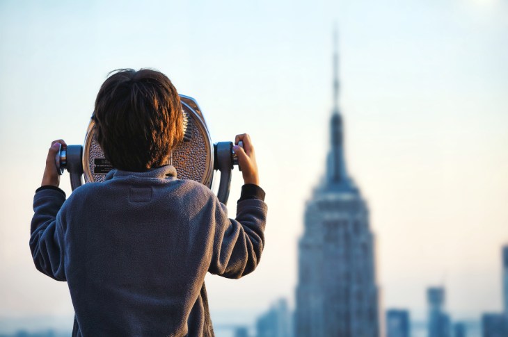 child looking through binoculars in NYC