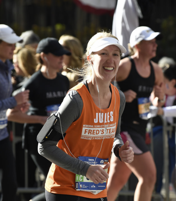 Australian woman running in New York City Marathon wearing an orange shirt