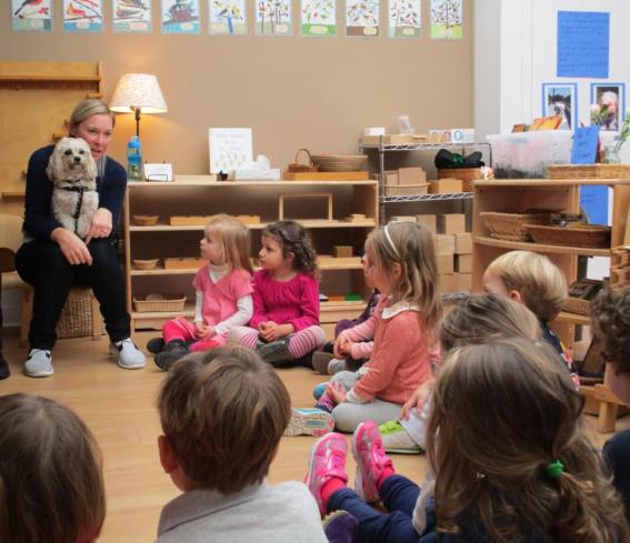 Cara Zelas author and educator with her dog in a classroom of preschool children