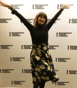 happy woman with arms in air Olivia Jones