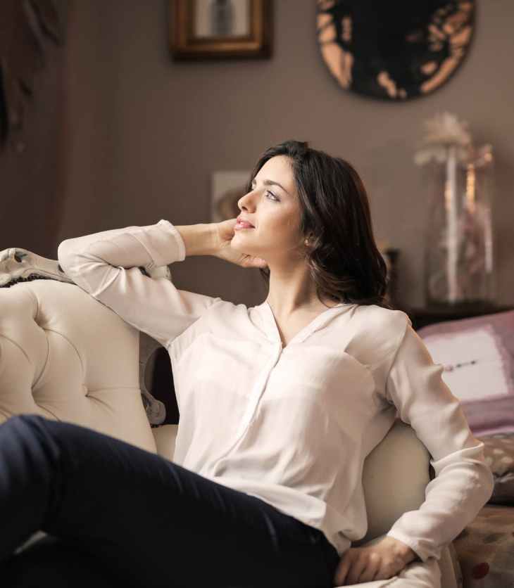 woman in white dress shirt and black pants