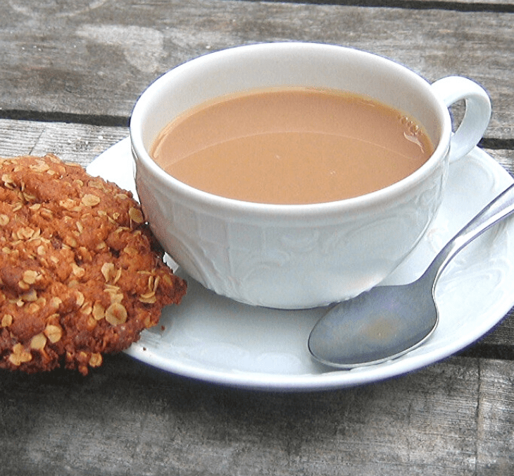 Anzac oatmeal biscuit cookie and cup of coffee on a table