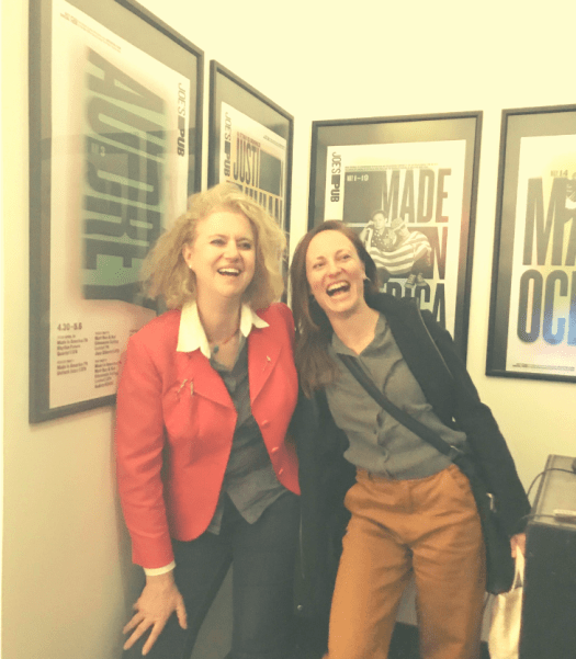two women laughing at the theatre