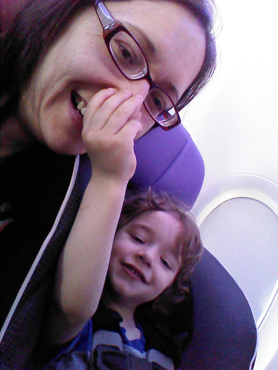 mother with toddler on airplane