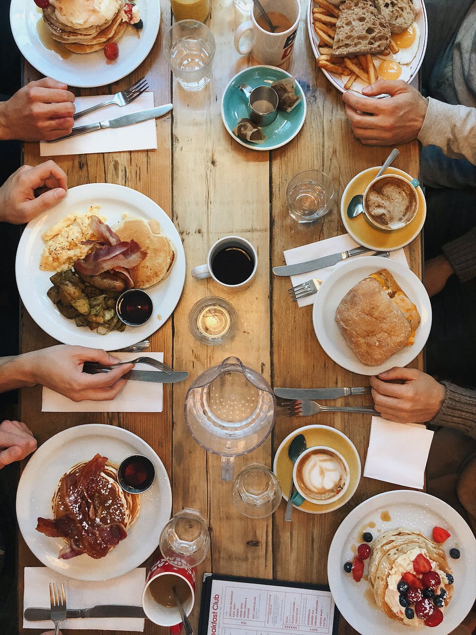 assorted variety of foods on plates on dining table