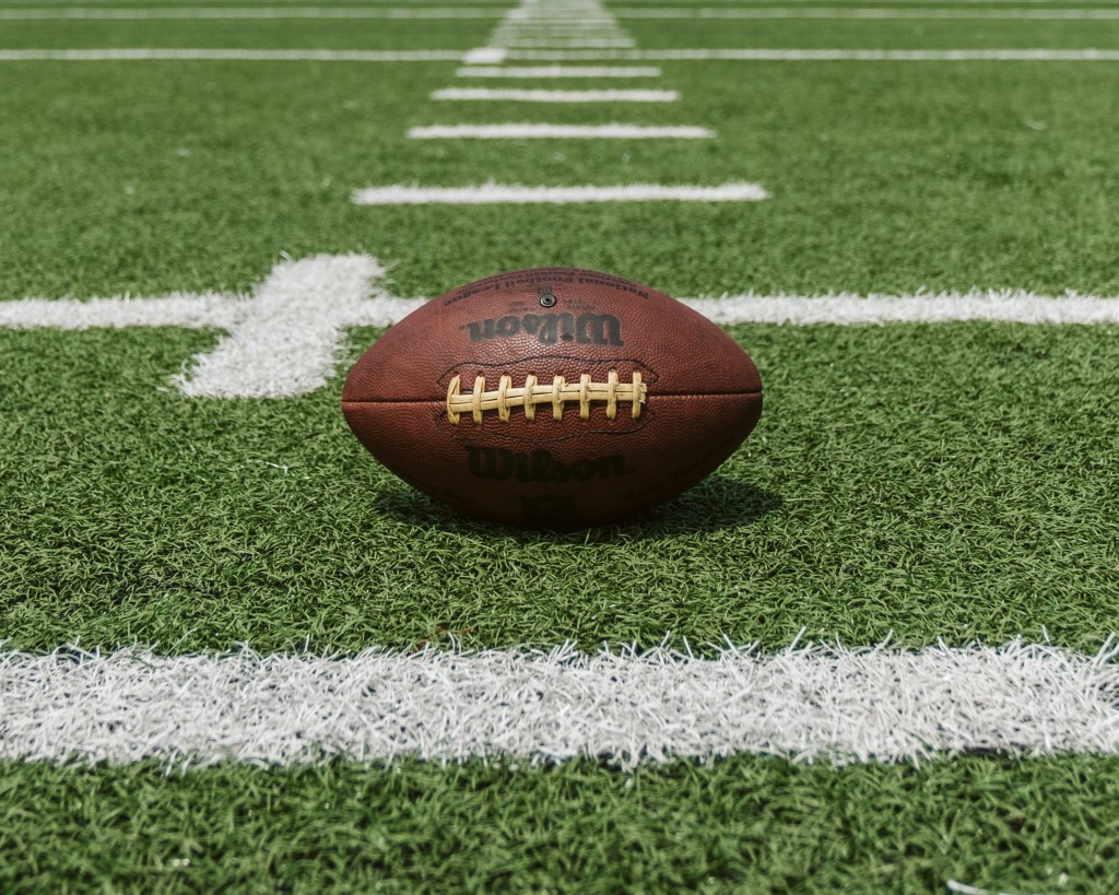 A football on the field before a game.
